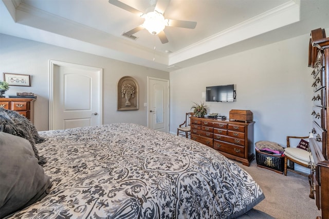 carpeted bedroom with a ceiling fan, a raised ceiling, crown molding, and visible vents