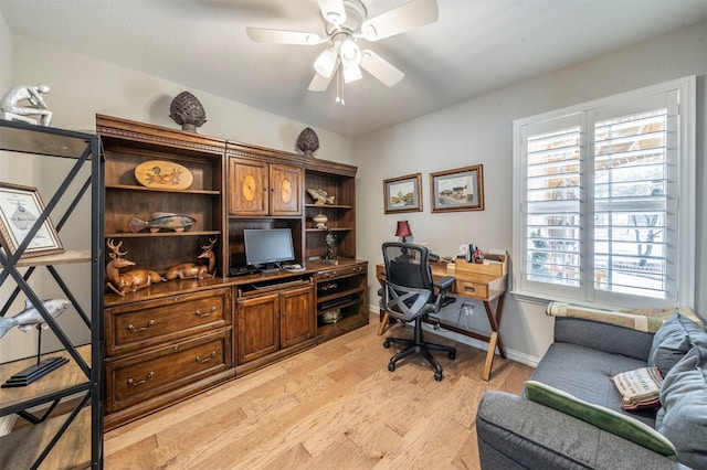 office featuring light wood-style flooring, baseboards, and ceiling fan