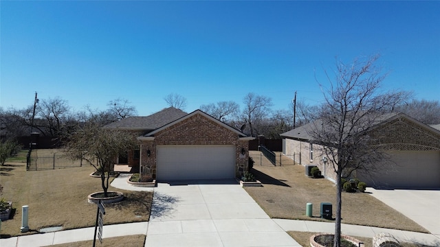 view of front of home with fence, concrete driveway, an attached garage, a shingled roof, and brick siding