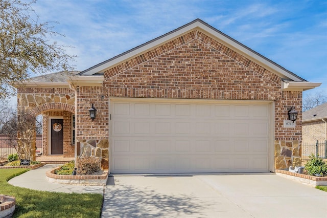 ranch-style home featuring brick siding, stone siding, and concrete driveway