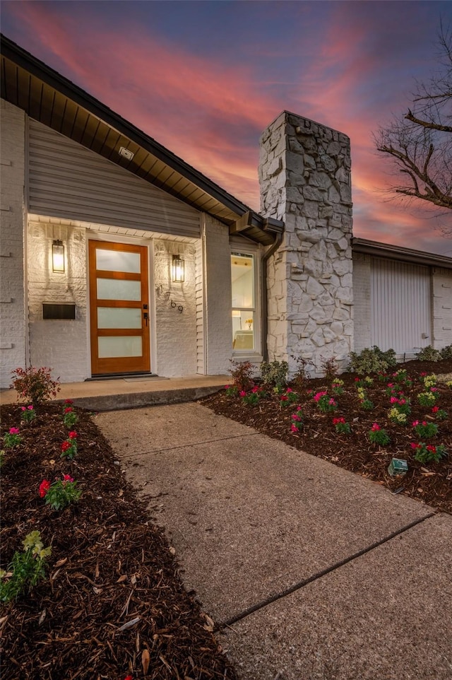 doorway to property featuring a chimney