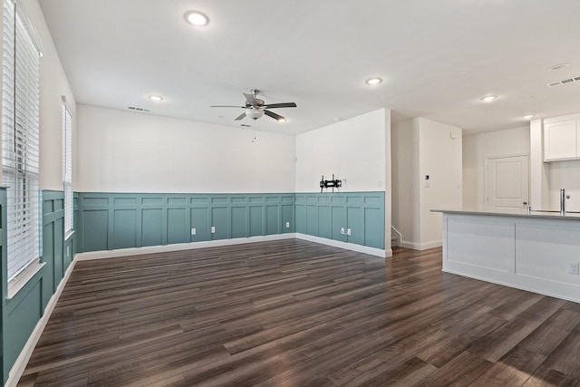 spare room with dark wood finished floors, recessed lighting, and visible vents