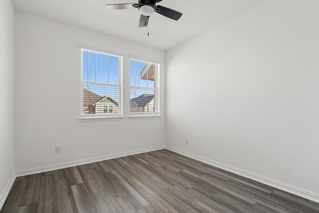 unfurnished room with ceiling fan, baseboards, and dark wood finished floors