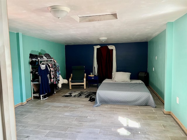 bedroom with wood finish floors and baseboards