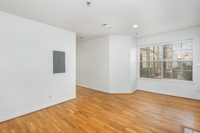 spare room with recessed lighting, visible vents, light wood-style floors, electric panel, and baseboards