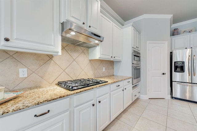 kitchen with appliances with stainless steel finishes, ornamental molding, white cabinetry, light tile patterned flooring, and under cabinet range hood