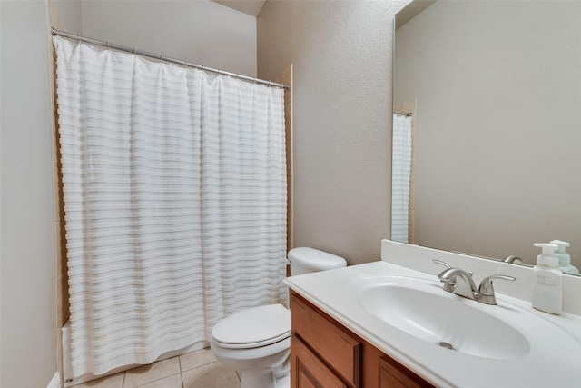 full bath with toilet, vanity, and tile patterned floors