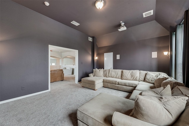 interior space with visible vents, vaulted ceiling, and baseboards