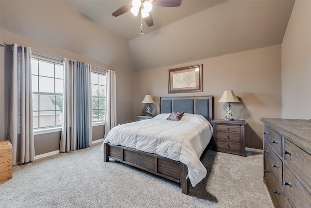 carpeted bedroom with lofted ceiling, baseboards, and a ceiling fan