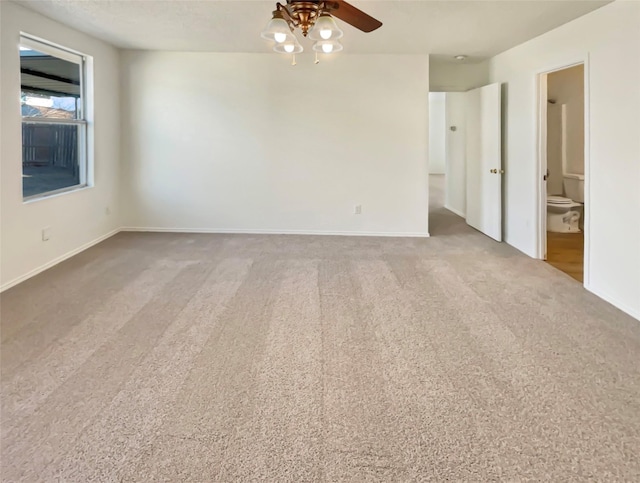 unfurnished room featuring ceiling fan, carpet flooring, and baseboards