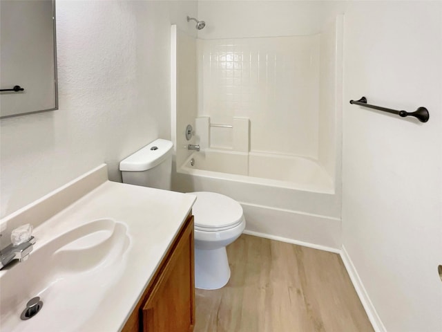 full bathroom featuring  shower combination, vanity, wood finished floors, and toilet