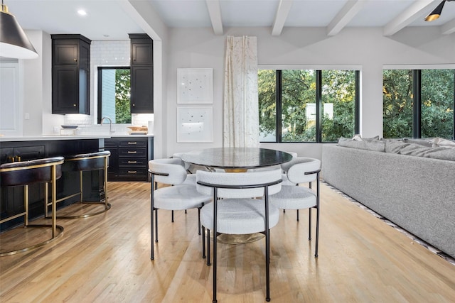 dining room with light wood-style floors, recessed lighting, and beam ceiling