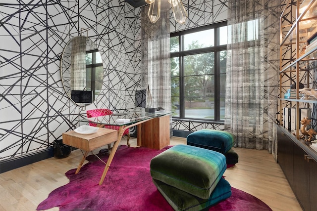 office space with an inviting chandelier and wood finished floors