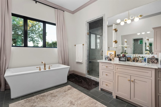 bathroom featuring crown molding, a freestanding bath, a stall shower, vanity, and tile patterned floors