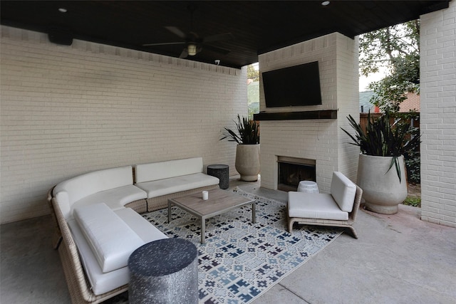 view of patio / terrace with ceiling fan and an outdoor living space with a fireplace