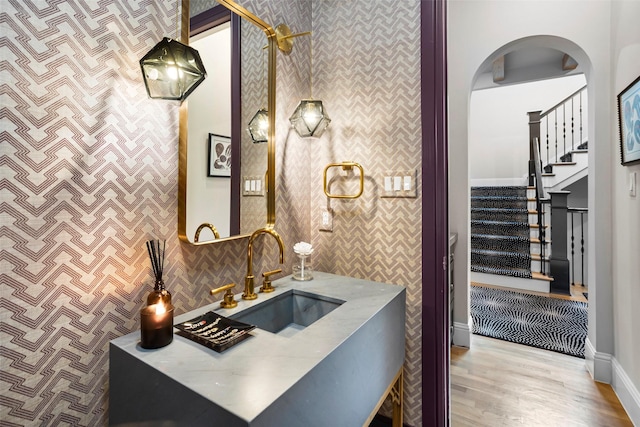 bathroom with tasteful backsplash, wood finished floors, and vanity