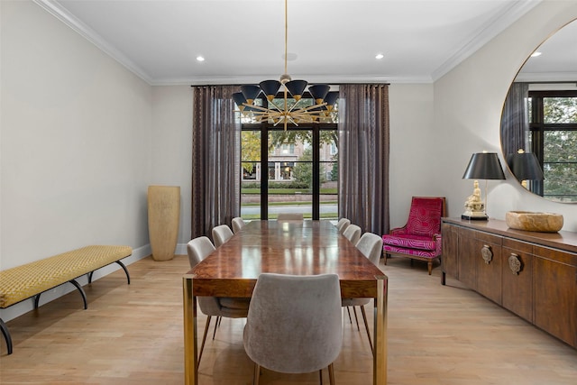 dining space with light wood-type flooring, an inviting chandelier, and ornamental molding