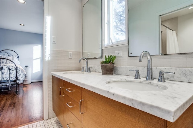 full bath featuring double vanity and a sink