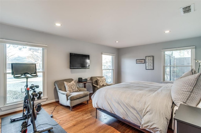 bedroom featuring light wood-style flooring, multiple windows, visible vents, and recessed lighting