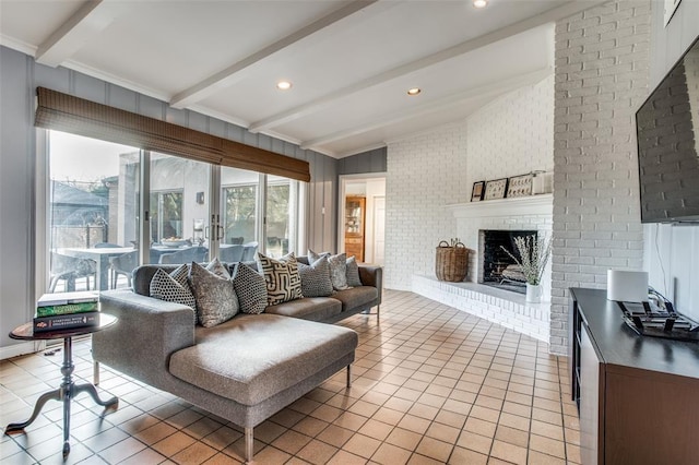 living room with light tile patterned floors, brick wall, a brick fireplace, and beamed ceiling