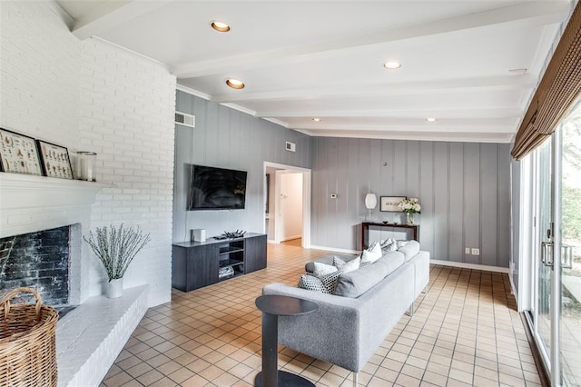 living area with baseboards, visible vents, tile patterned floors, a brick fireplace, and beam ceiling