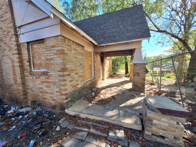 view of patio with fence and a carport