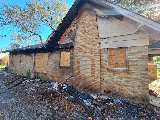 view of property exterior featuring brick siding