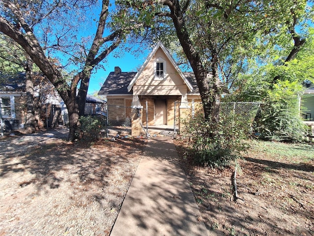 view of front facade with fence and a chimney