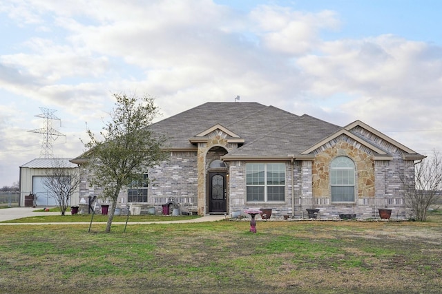 view of front of house with a garage, a shingled roof, concrete driveway, a front yard, and brick siding