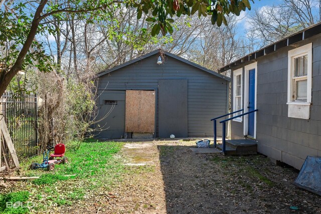 exterior space with fence and an outbuilding
