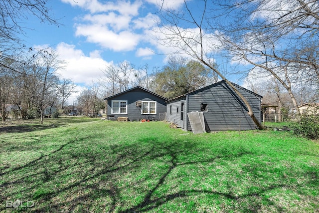 rear view of house featuring a lawn and entry steps