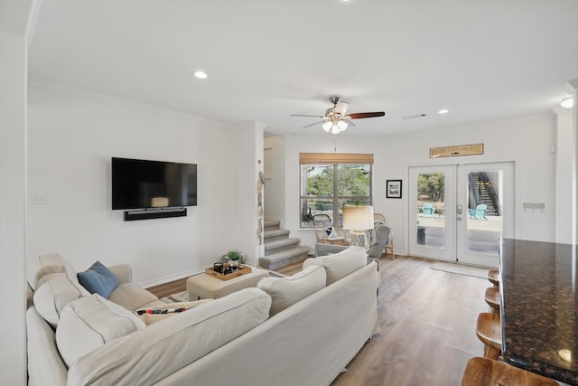 living area featuring french doors, ornamental molding, wood finished floors, and recessed lighting