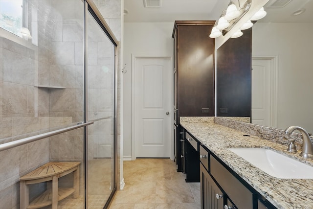 bathroom with a stall shower, visible vents, a chandelier, and vanity