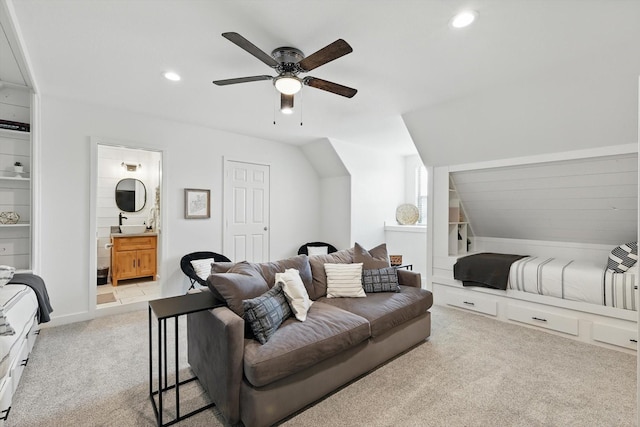 bedroom with connected bathroom, recessed lighting, light colored carpet, and vaulted ceiling