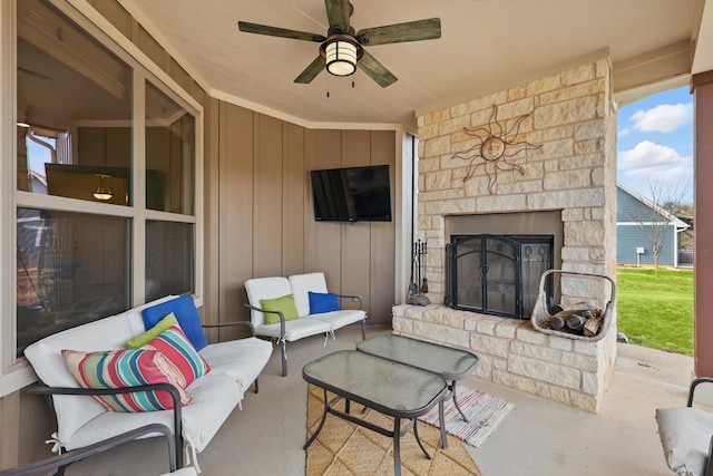 view of patio featuring ceiling fan and an outdoor living space with a fireplace