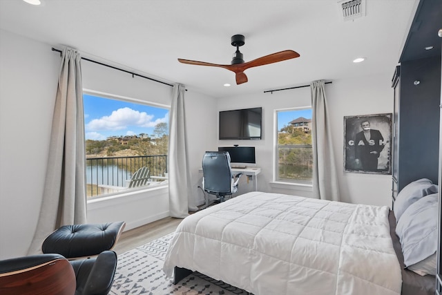 bedroom featuring multiple windows, visible vents, wood finished floors, and recessed lighting