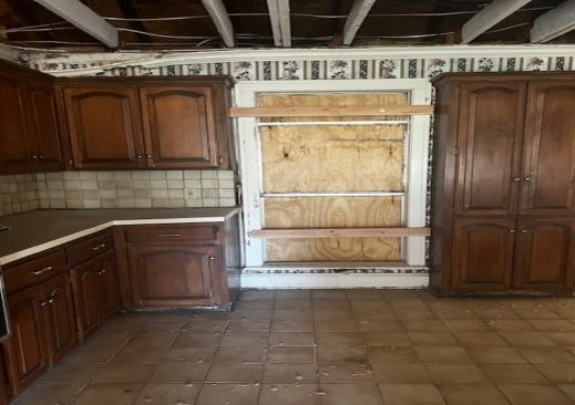 kitchen featuring light countertops and backsplash