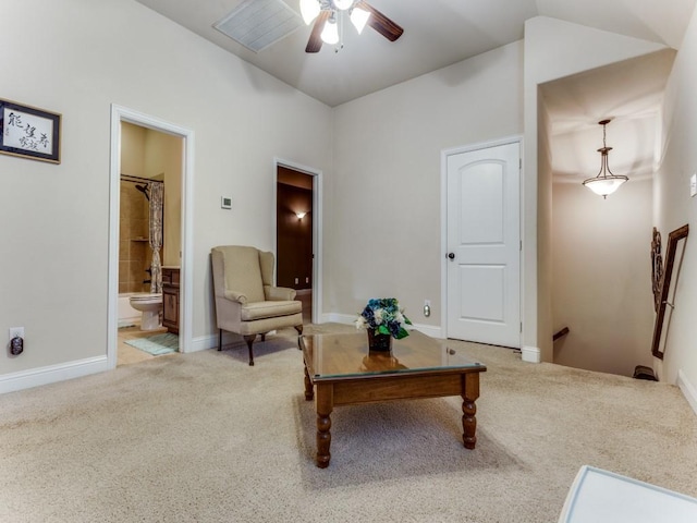 living area with ceiling fan, baseboards, and light colored carpet