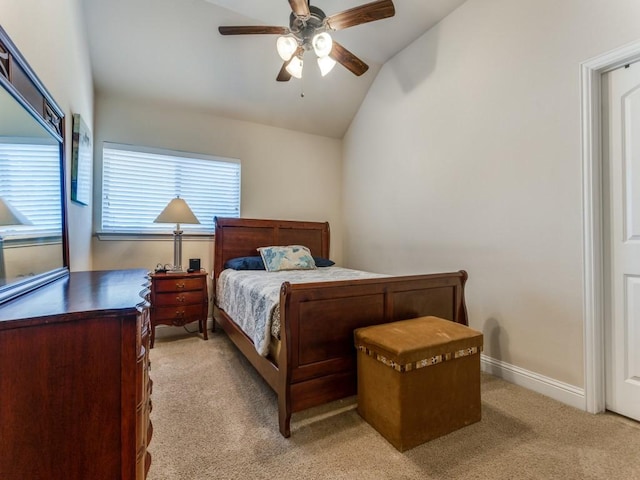 bedroom featuring ceiling fan, baseboards, vaulted ceiling, and light colored carpet