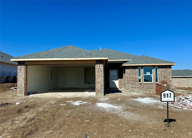 917 E 3rd St, Coleman, TX 76834 - view of front facade with brick siding and roof with shingles