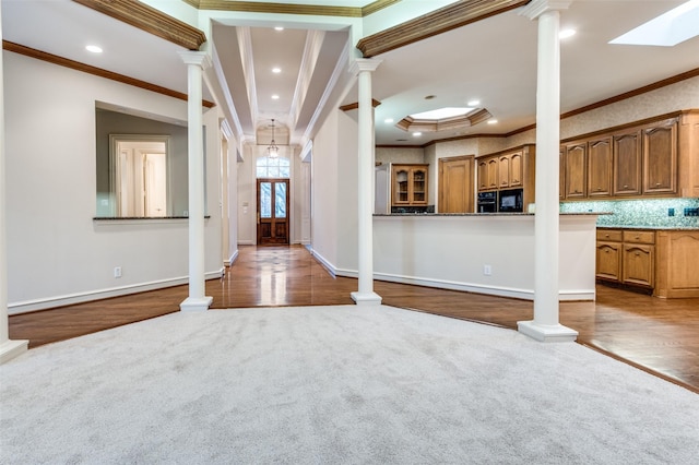 entryway featuring dark carpet and ornate columns