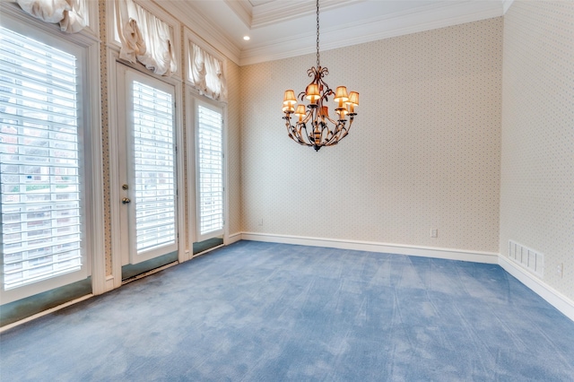 carpeted spare room featuring visible vents, crown molding, a notable chandelier, and wallpapered walls