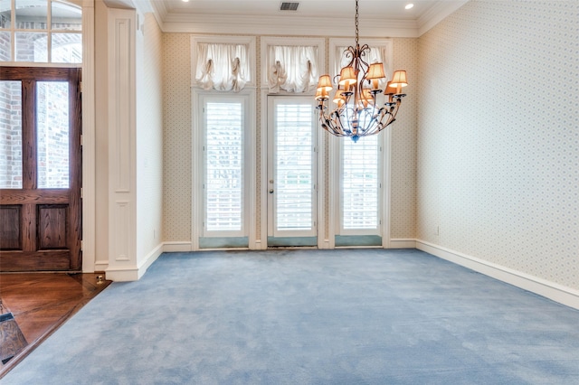 interior space with crown molding, baseboards, carpet flooring, and wallpapered walls