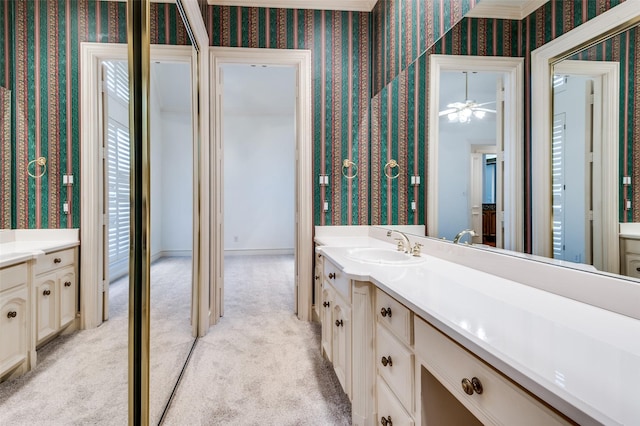 bathroom featuring wallpapered walls and vanity