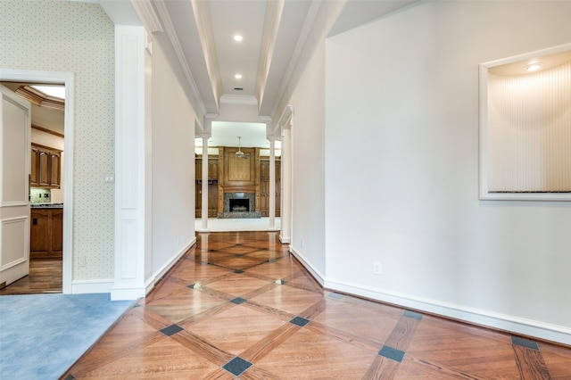 corridor with wallpapered walls, baseboards, crown molding, and recessed lighting