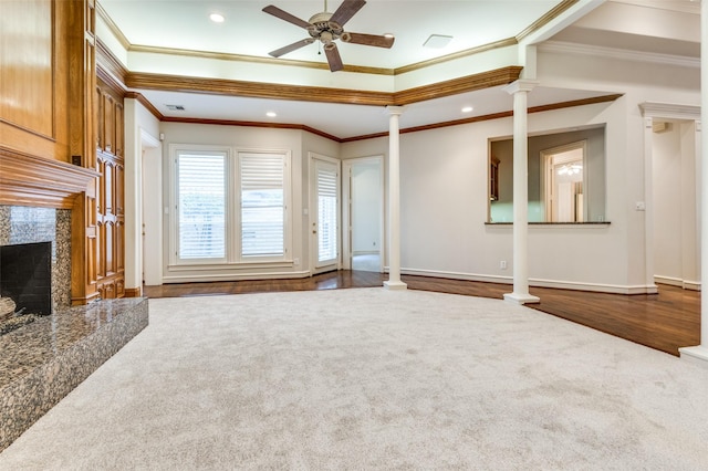 unfurnished living room with dark wood-style floors, a fireplace, decorative columns, ceiling fan, and baseboards