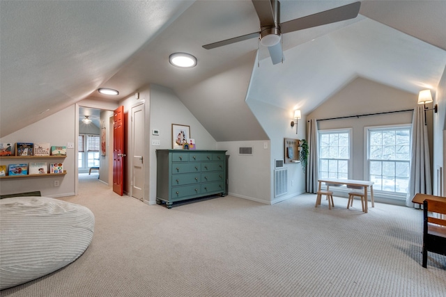 interior space featuring lofted ceiling, light colored carpet, and visible vents