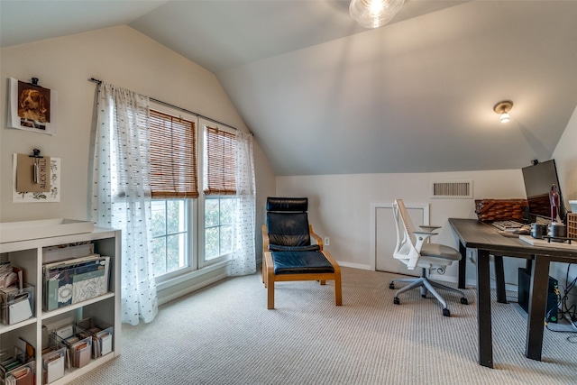 carpeted office featuring vaulted ceiling, visible vents, and baseboards