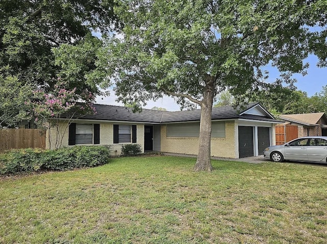 ranch-style house featuring a garage, a front lawn, fence, and brick siding