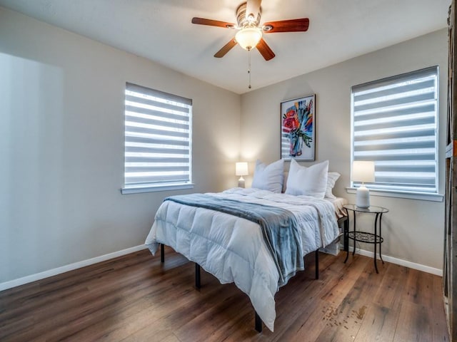 bedroom featuring ceiling fan, baseboards, and wood finished floors